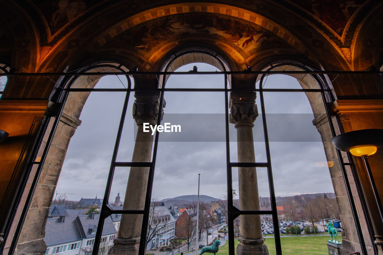 LOW ANGLE VIEW OF BUILDING SEEN THROUGH WINDOW