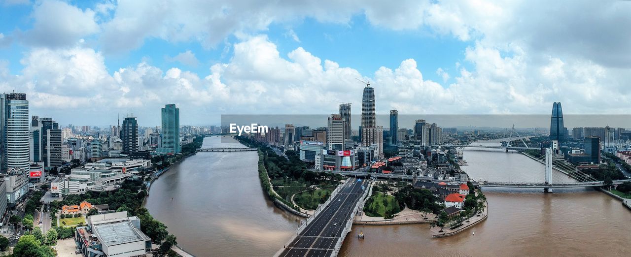 Panoramic view of river amidst buildings against sky