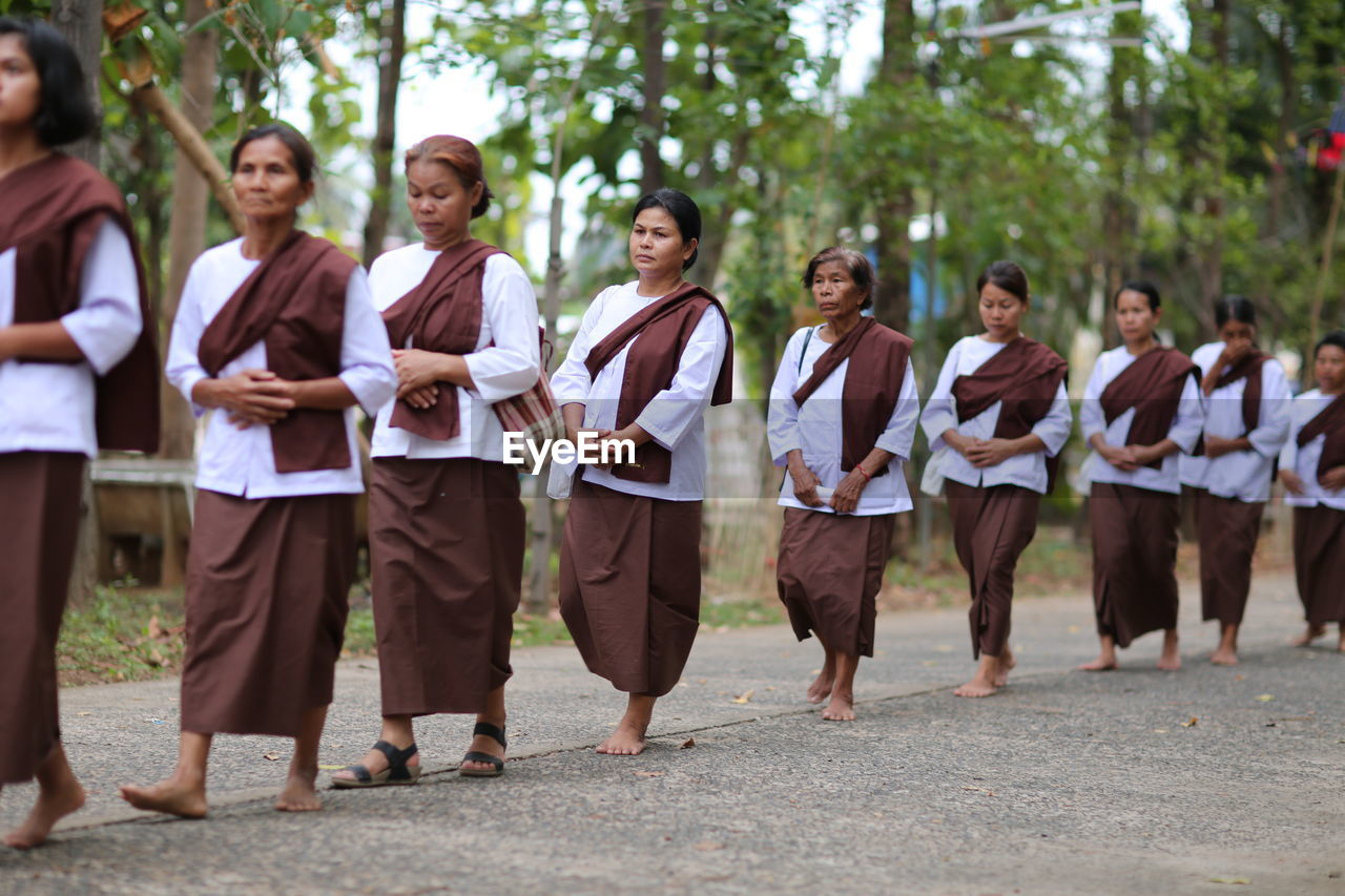 GROUP OF PEOPLE WALKING ON THE GROUND