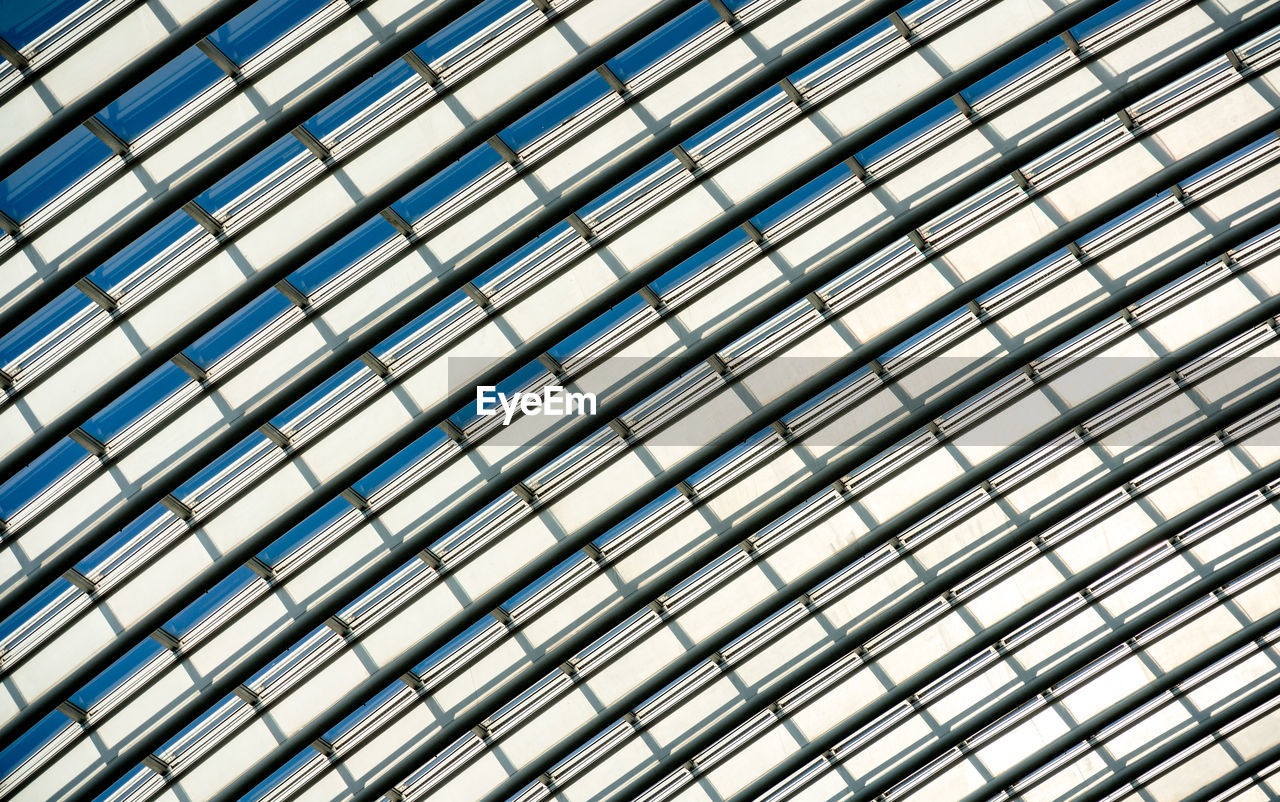 LOW ANGLE VIEW OF MODERN GLASS CEILING