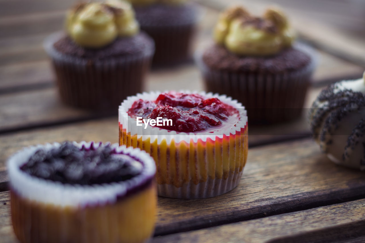 Close-up of cupcakes on table.
focus on the red filling cupcake