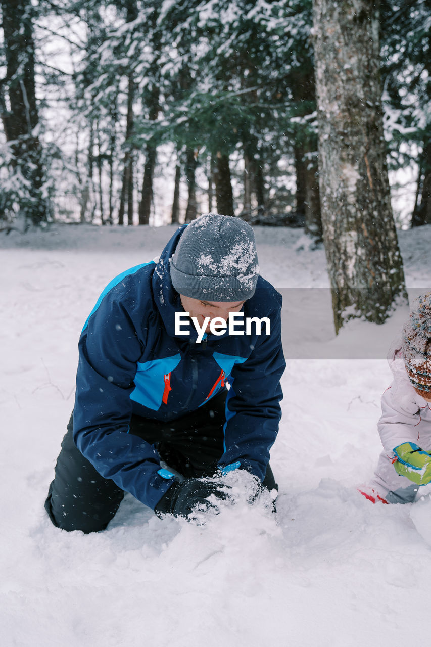 man skiing on snow covered landscape