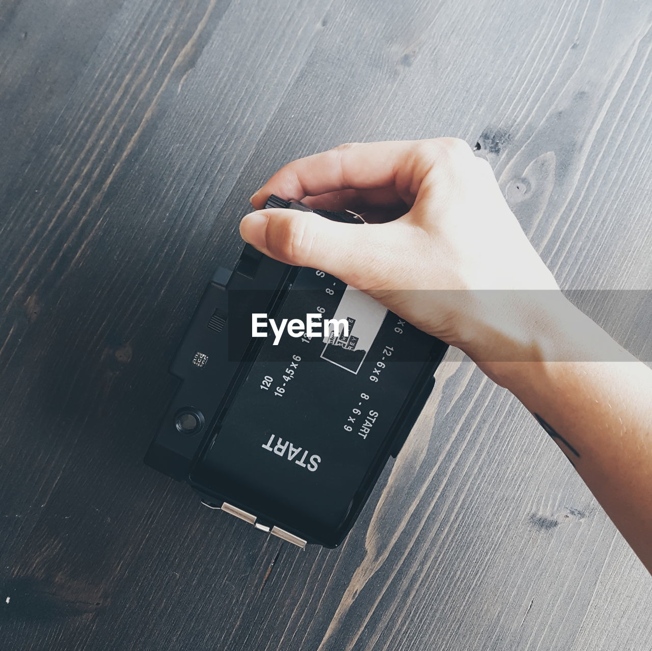 Close-up of hand holding camera