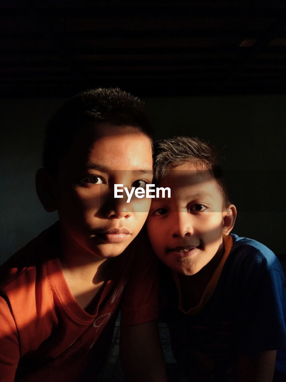 Portrait of brothers in darkroom