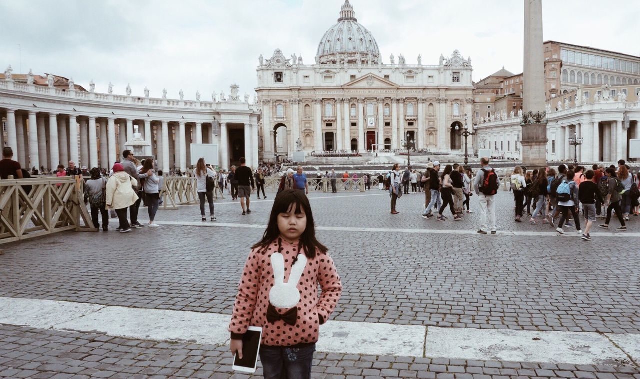 Girl standing with digital tablet against st peters basilica