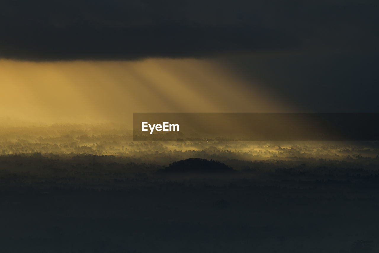 Scenic view of silhouette mountain against sky at sunset