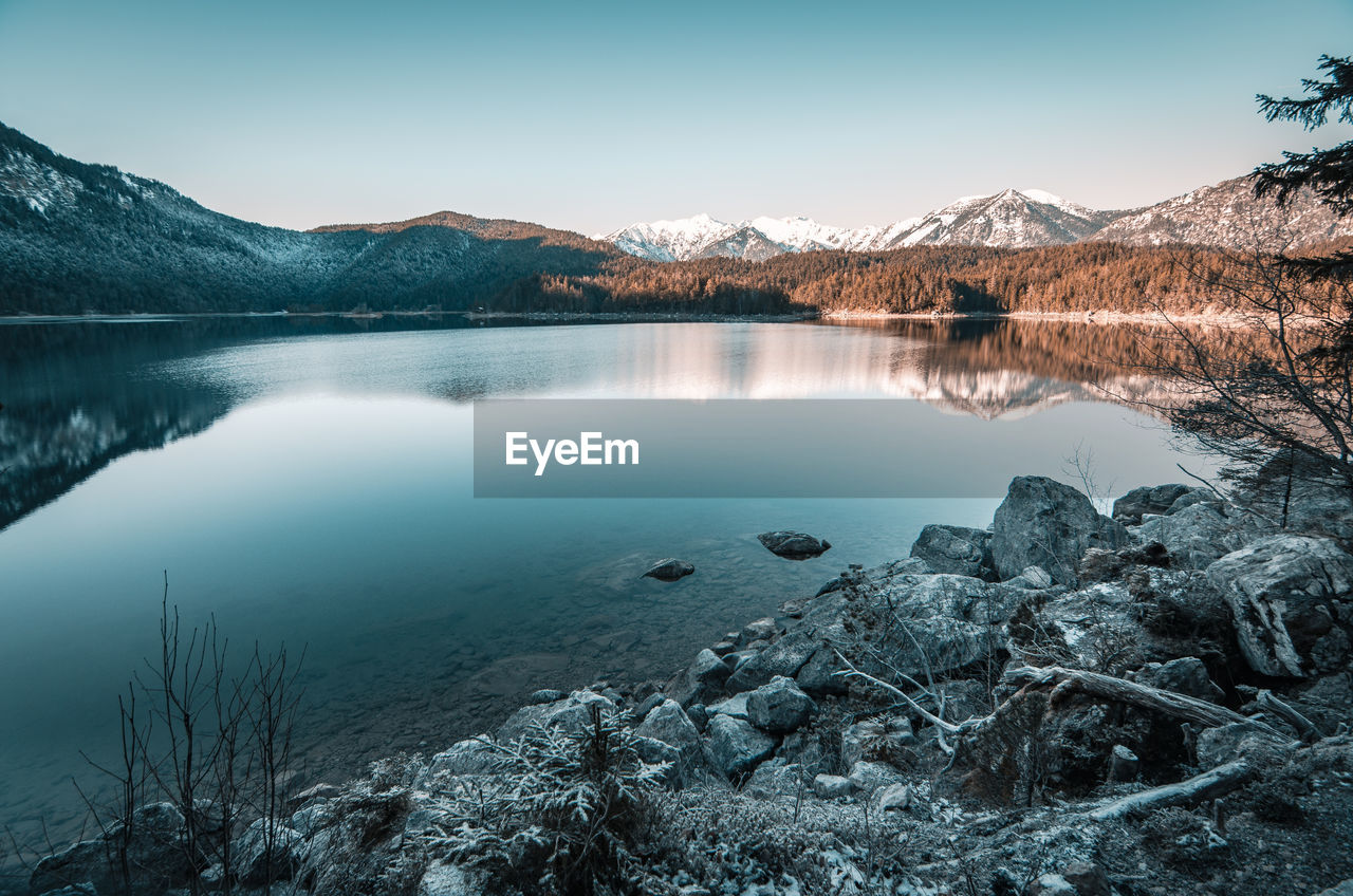 Scenic view of lake and mountains against sky