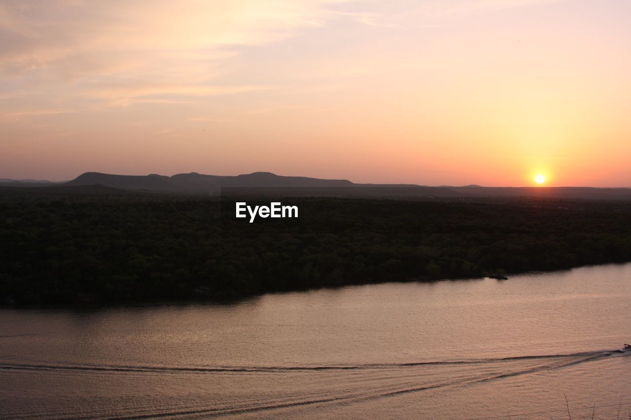 SCENIC VIEW OF SUNSET OVER LANDSCAPE