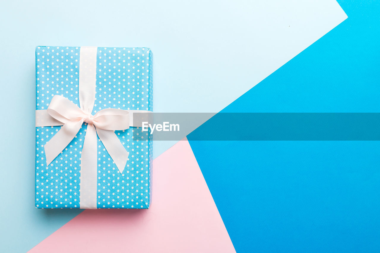high angle view of gift box on colored background