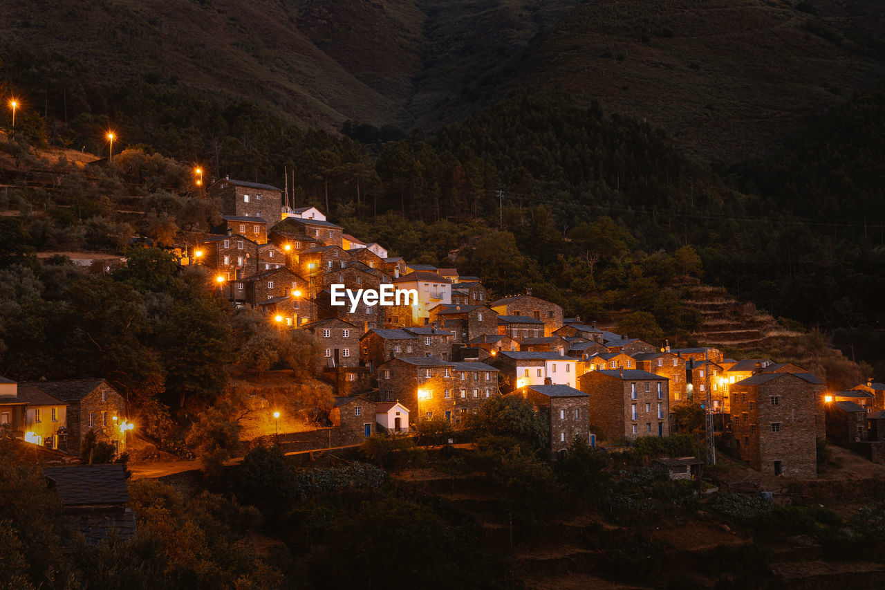 High angle view of illuminated buildings in city at night