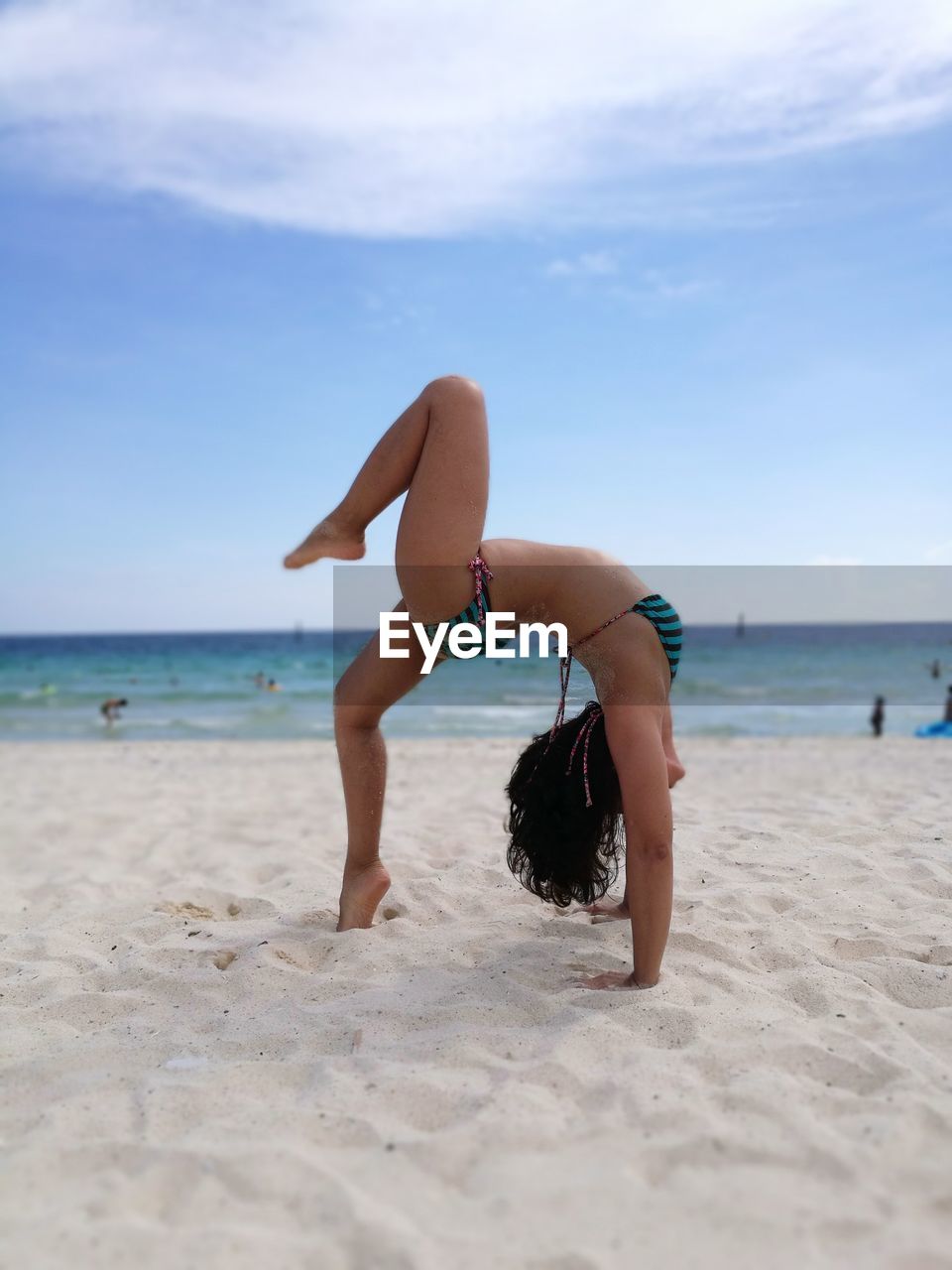 Full length of woman at beach against sky