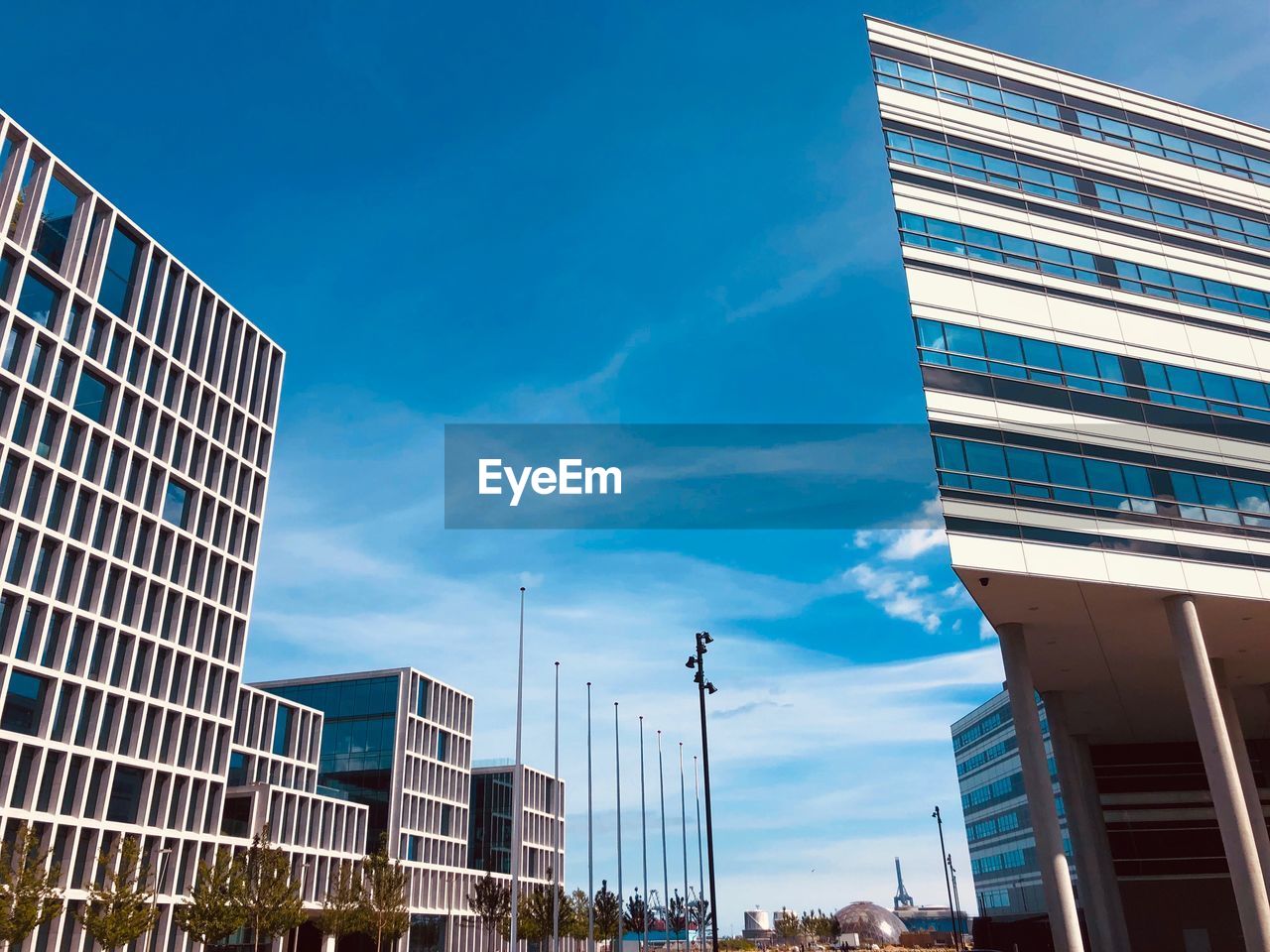 Low angle view of modern buildings against blue sky