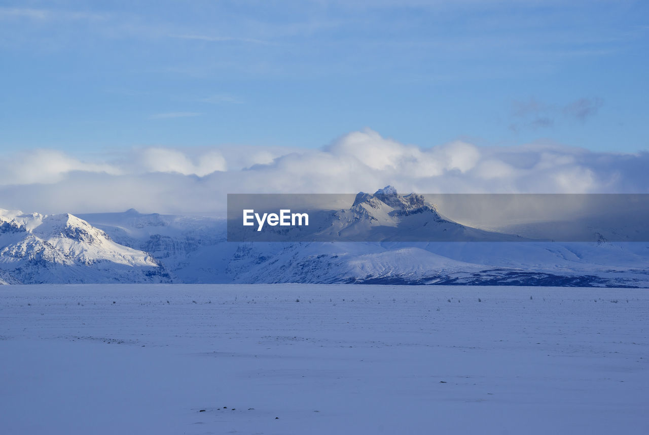 Scenic view of snowcapped mountains against sky