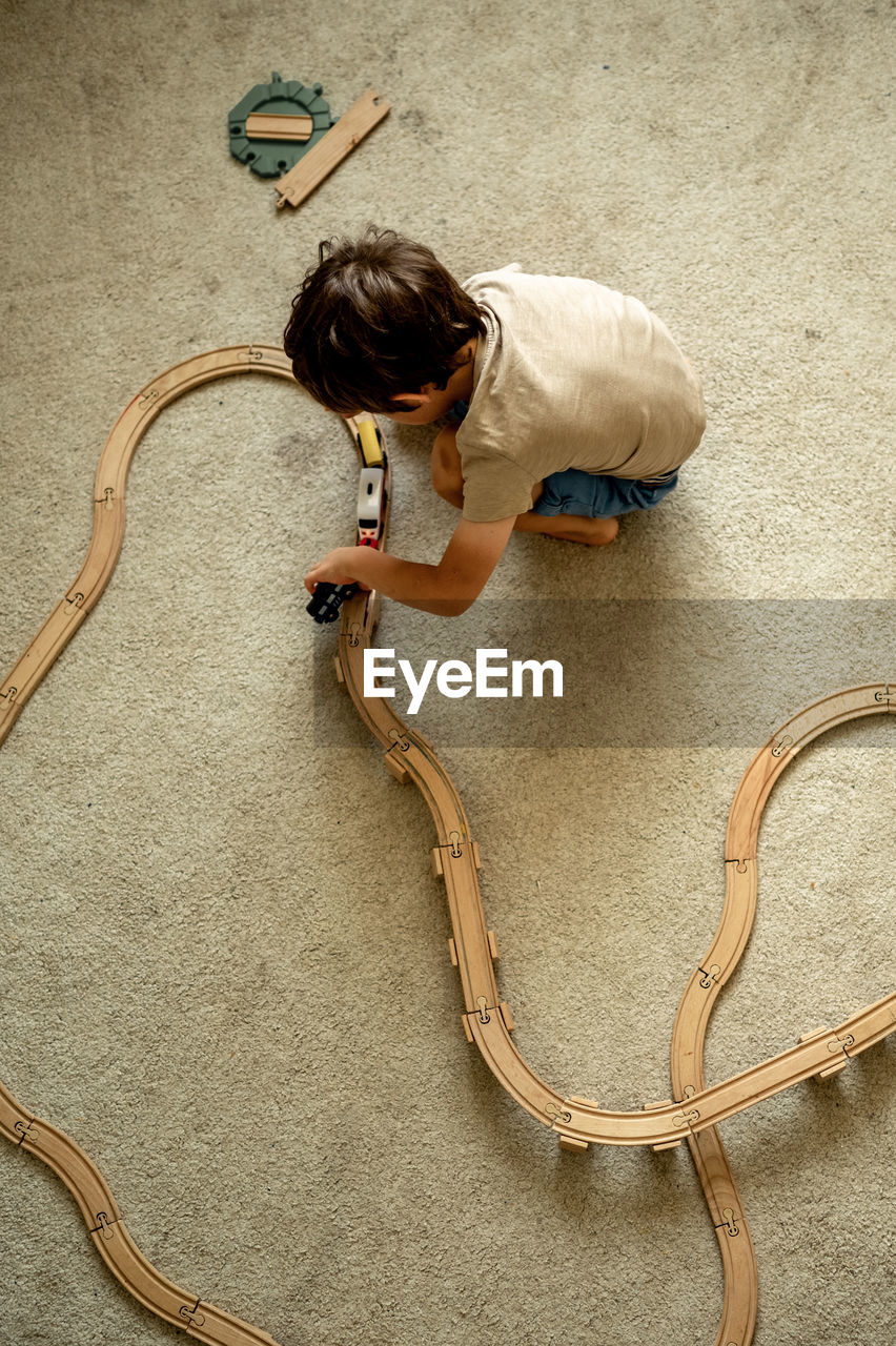 high angle view of boy playing with heart shape on stage