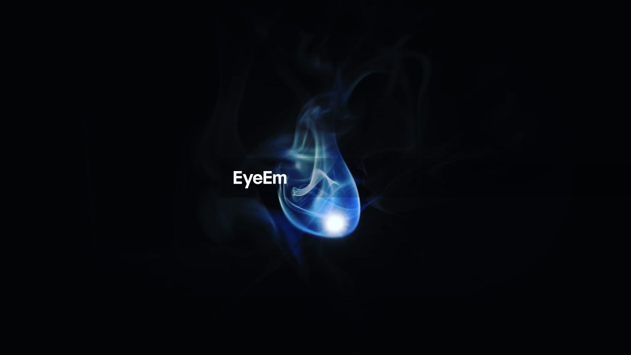 Close-up of smoke over black background