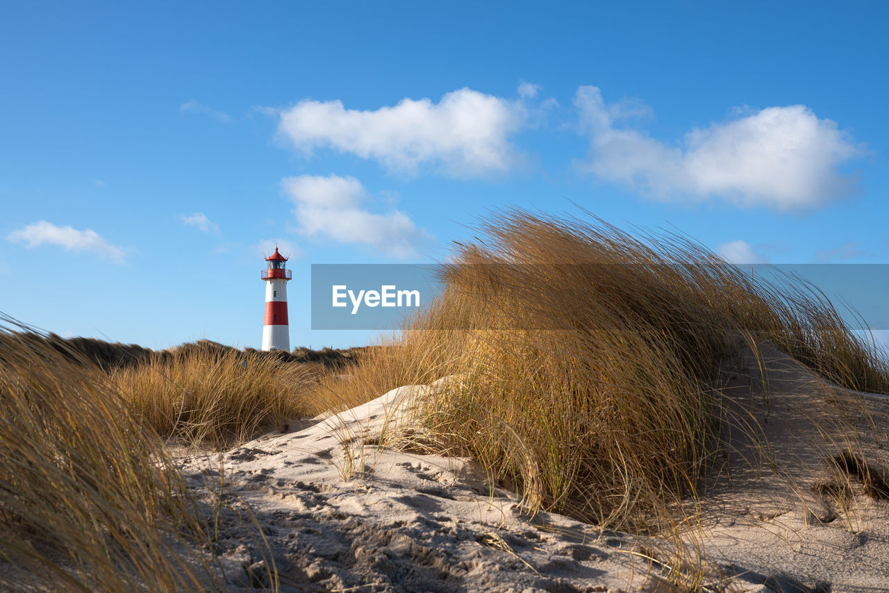 Panoramic image of list east lighthouse against blue sky, sylt, north frisia, germany