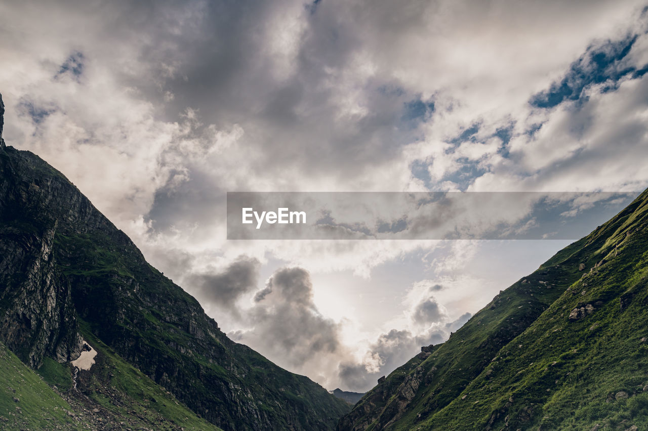 nature, mountain, cloud, environment, sky, landscape, scenics - nature, mountain range, beauty in nature, land, travel, travel destinations, highland, valley, dramatic sky, overcast, plant, no people, tourism, outdoors, forest, cloudscape, panoramic, mountain peak, activity, non-urban scene, fog, pinaceae, social issues, tranquility, grass, summer, tree, trip, coniferous tree, holiday, vacation, environmental conservation, tranquil scene, green, rock, idyllic