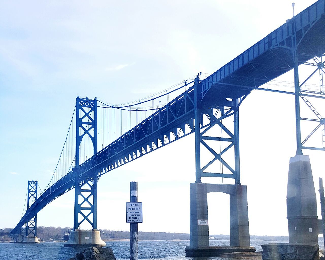 Low angle view of mount hope bridge over sea against sky