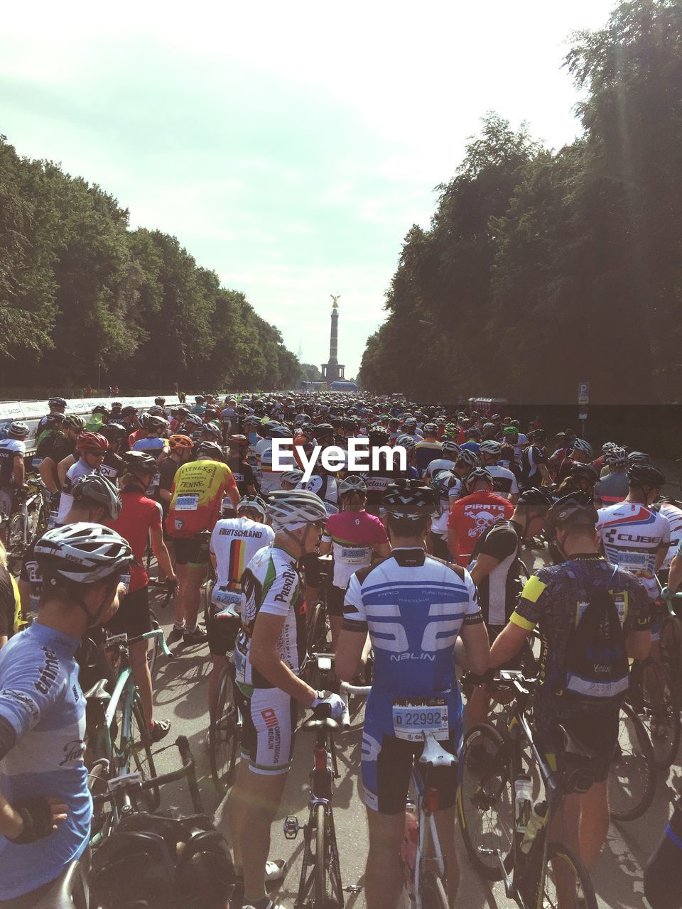 Athletes with bicycles at park amidst trees