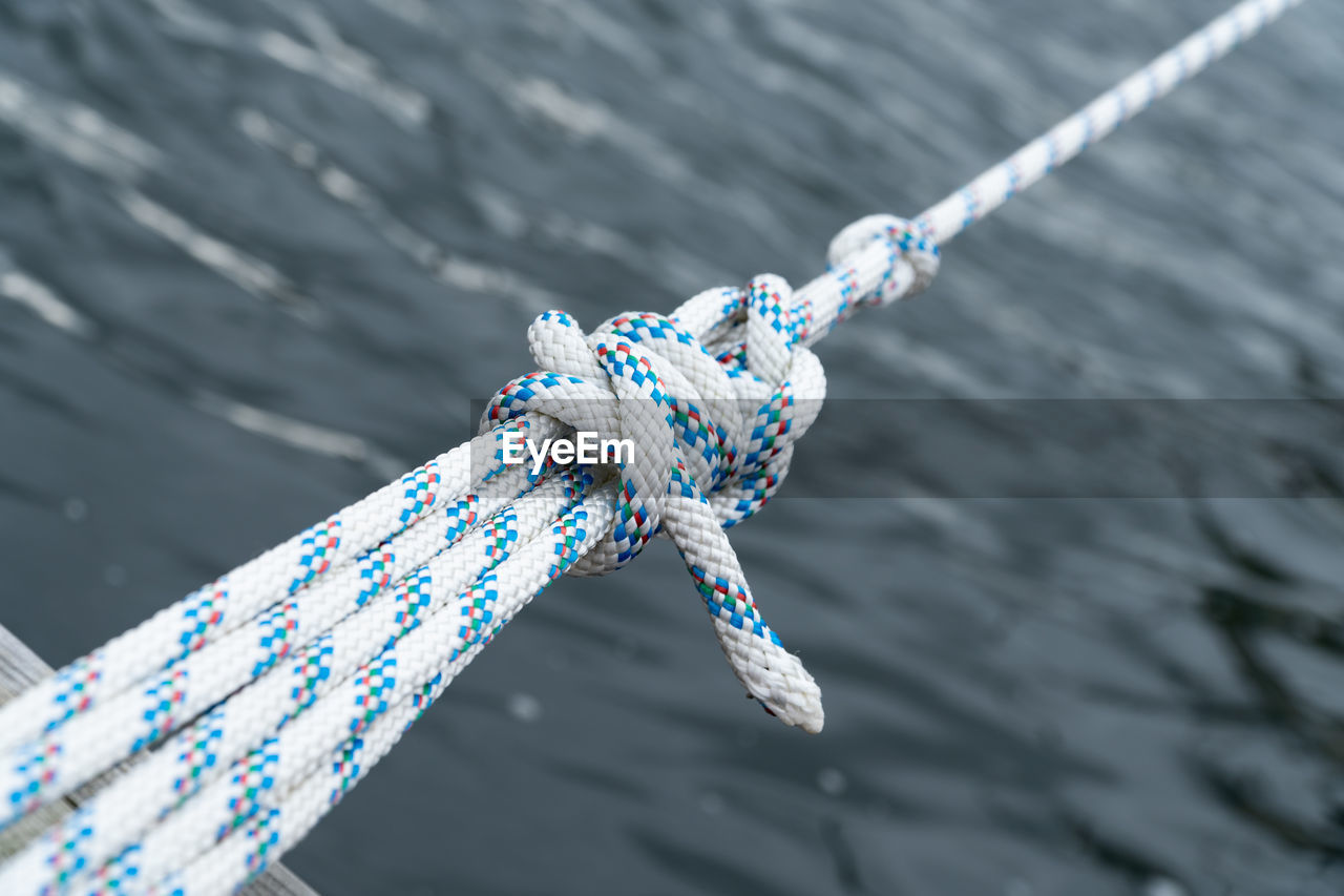 High angle view of ropes tied over sea
