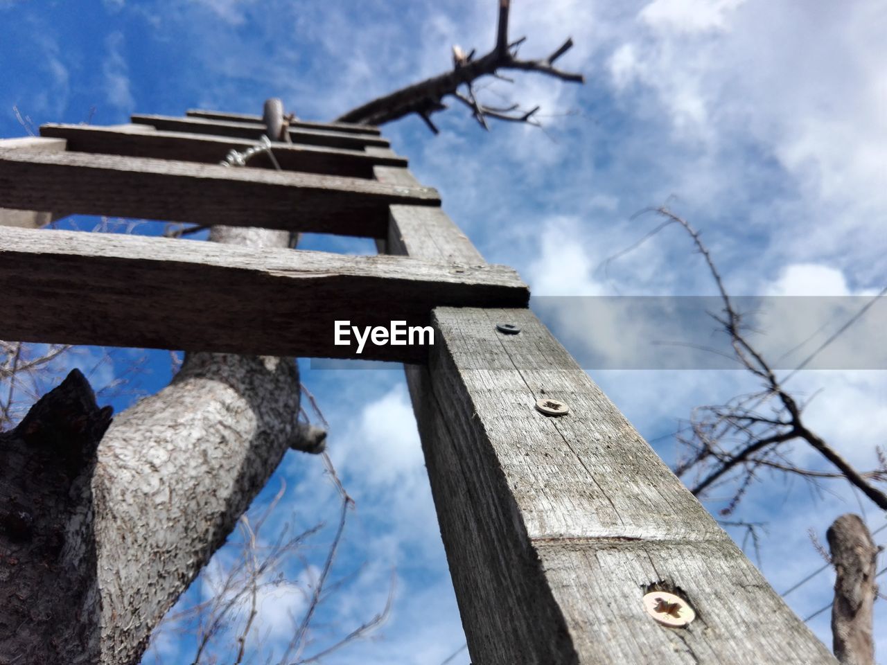 Low angle view of wooden ladder uppon sky