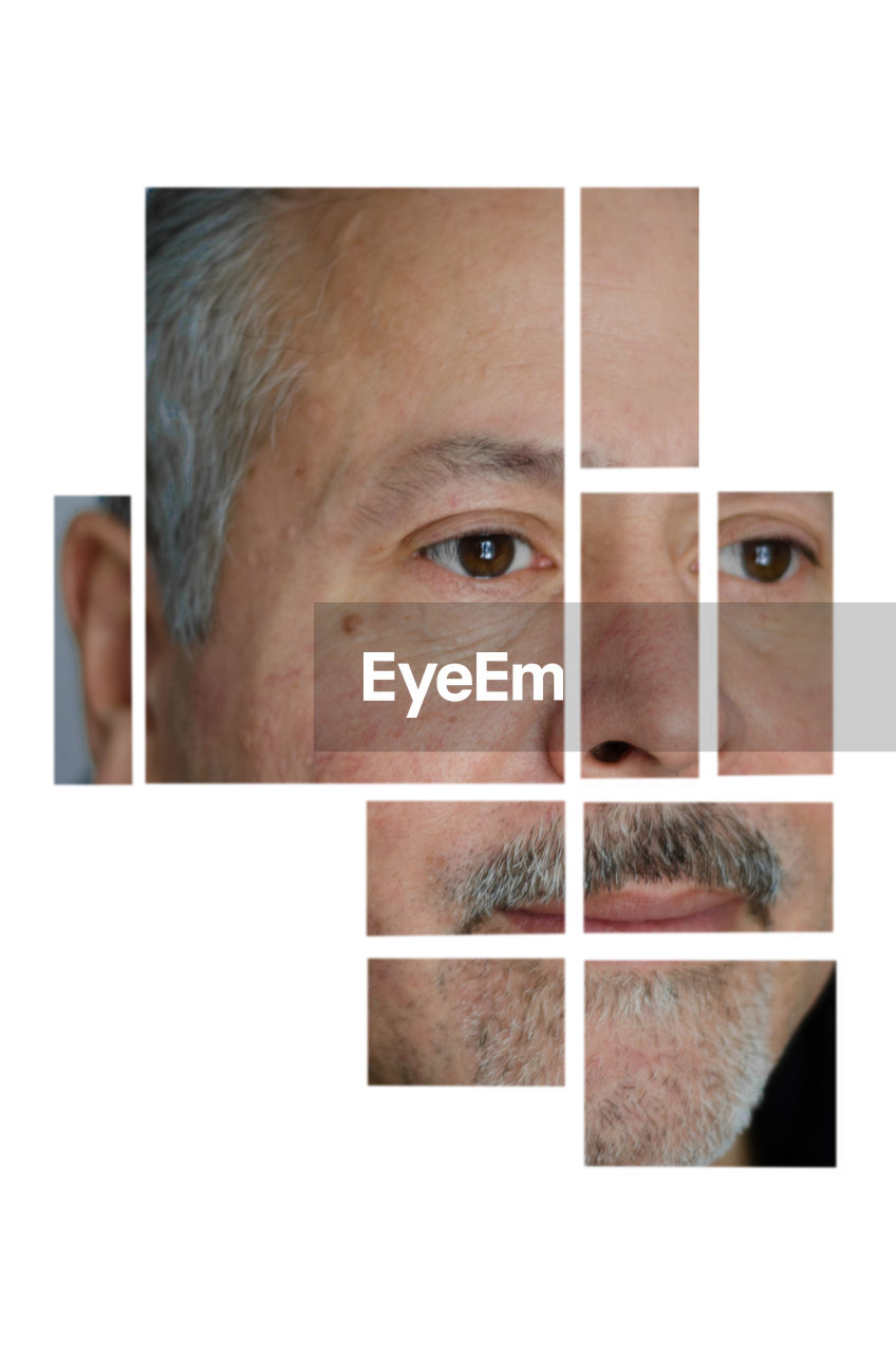 CLOSE-UP PORTRAIT OF MAN AGAINST GRAY BACKGROUND