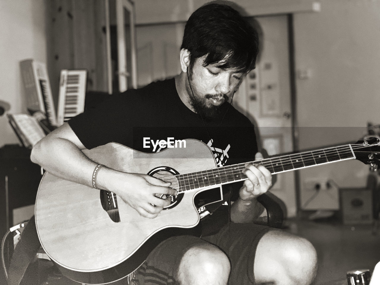 Man playing guitar while sitting at home