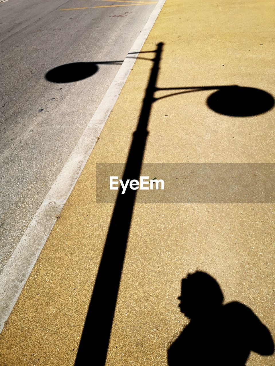 High angle view of shadow of people on street