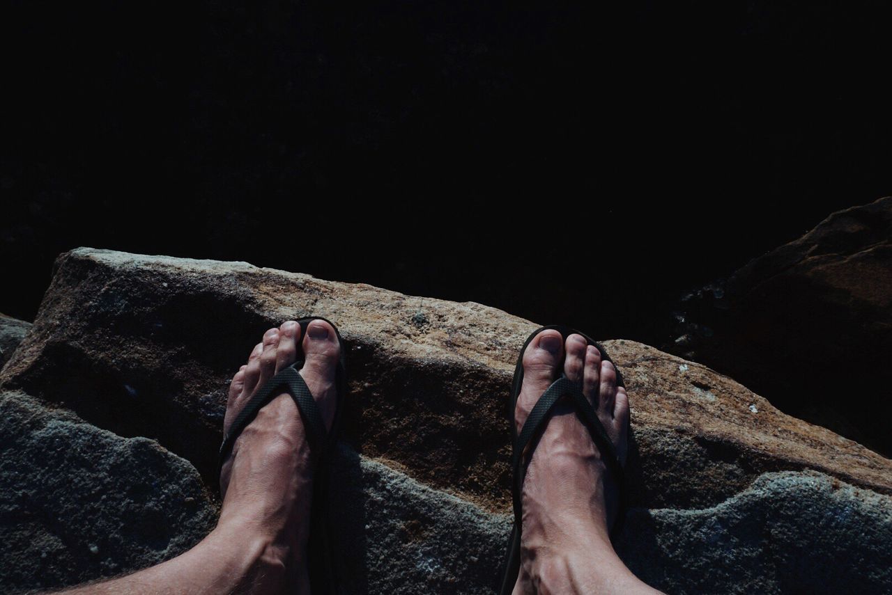 Low section of man standing on rock formation