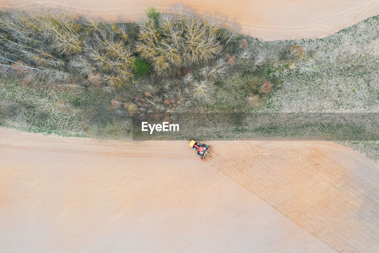 Agricultural machine cultivates the land. the view from the top. plowing land for planting crops.