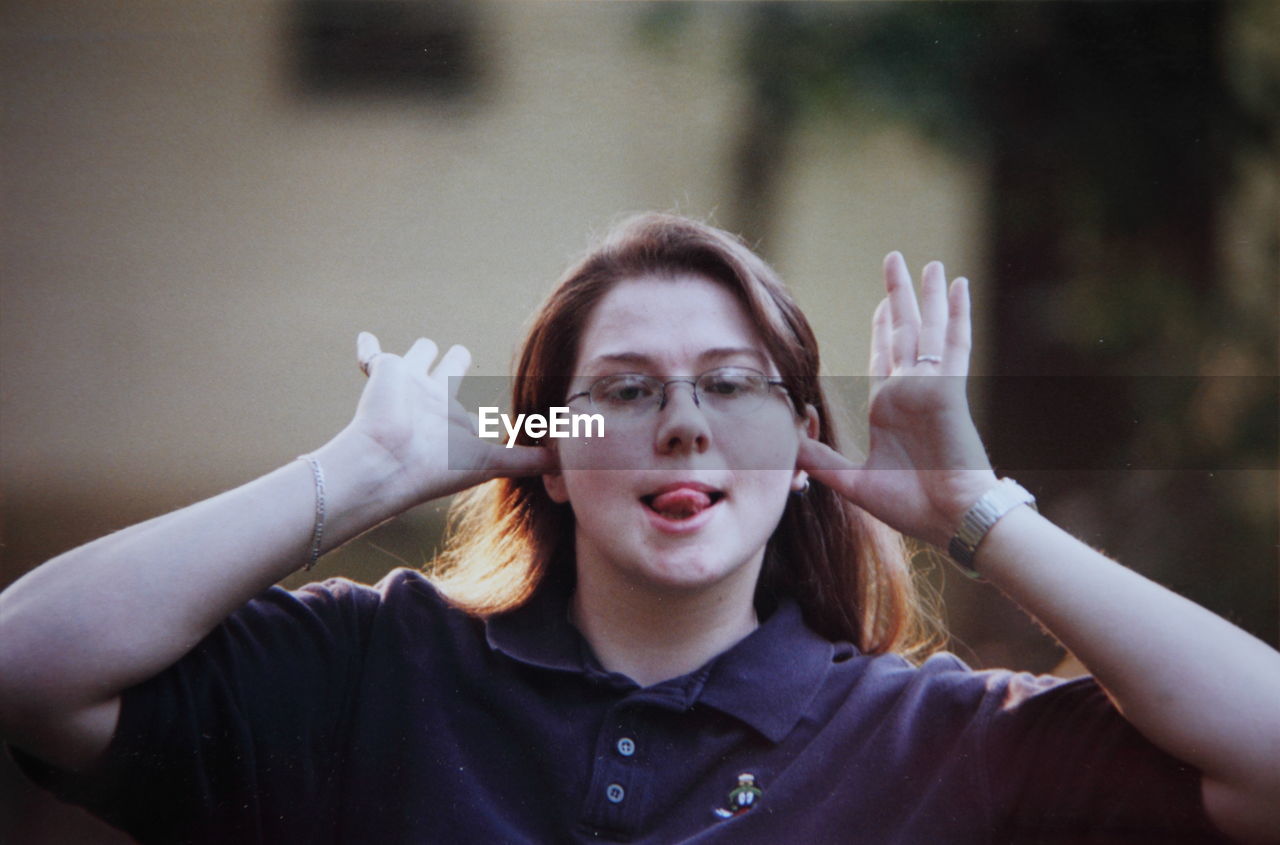 Portrait of woman making silly gesture