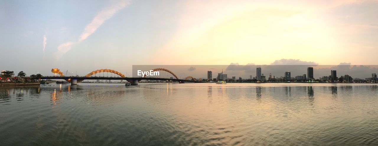 Panoramic view of bridge over river against sky during sunset