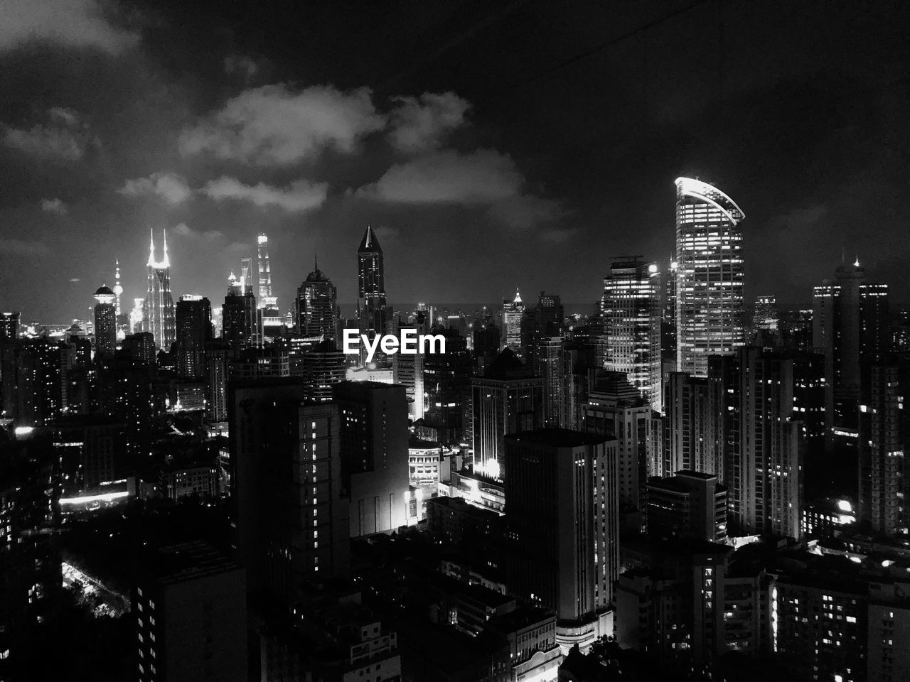 Illuminated buildings in city against sky at night. black and white portrait from shanghai. 