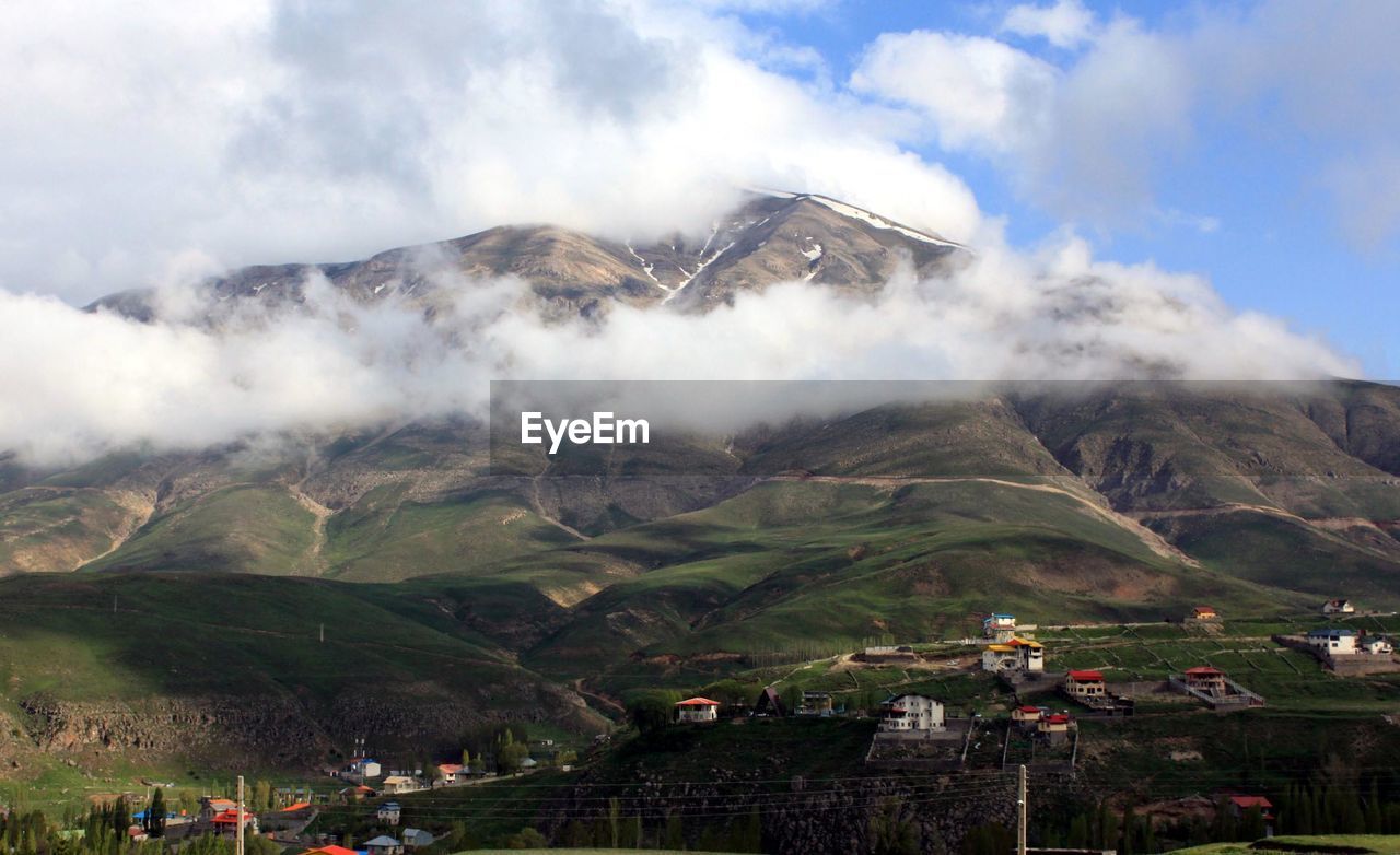 Scenic view of mountains against cloudy sky