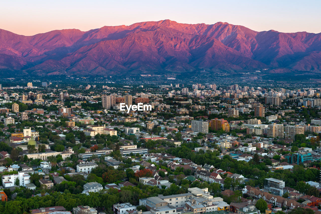 Aerial view of city against mountains