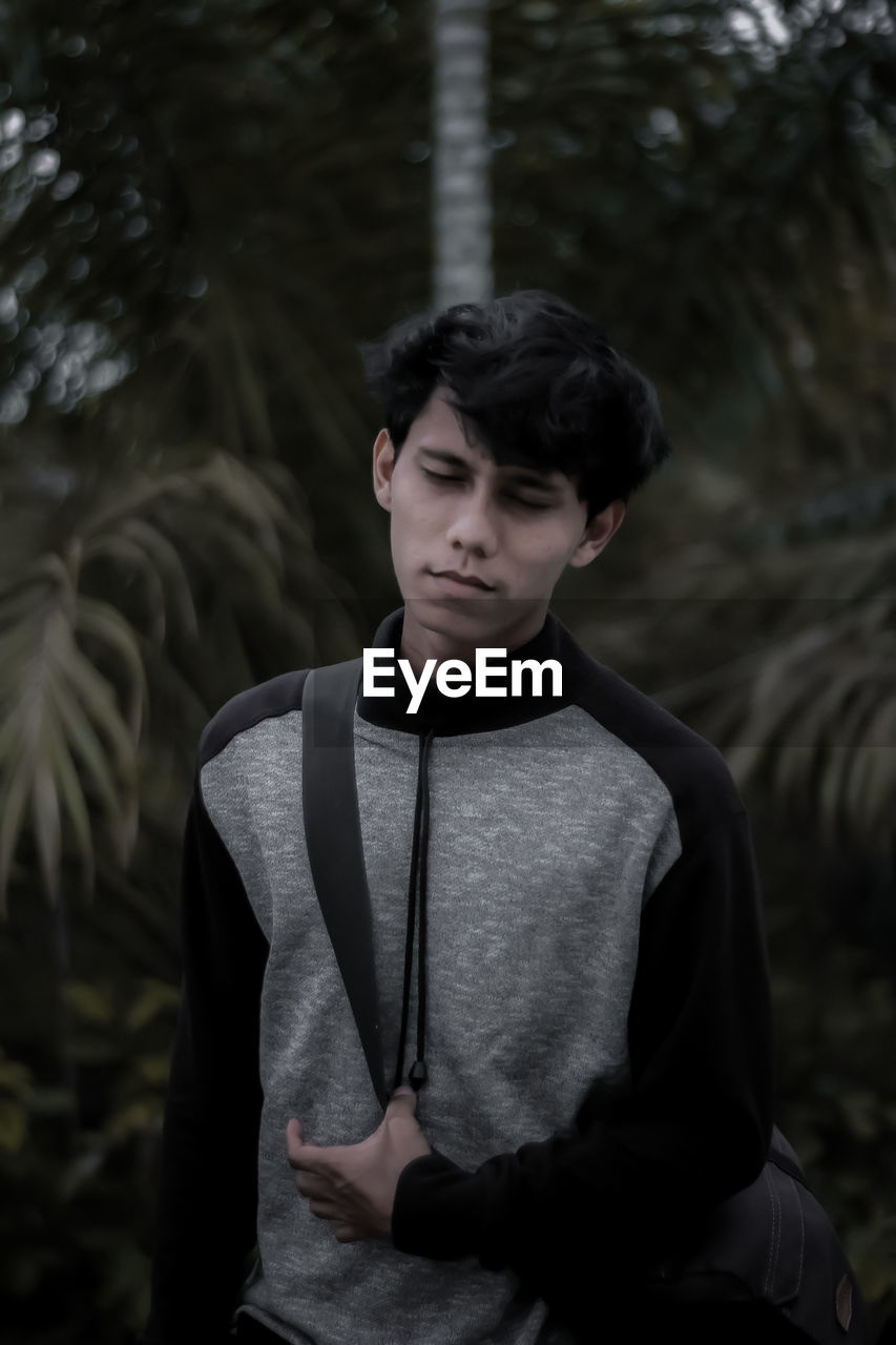 Portrait of young man looking away