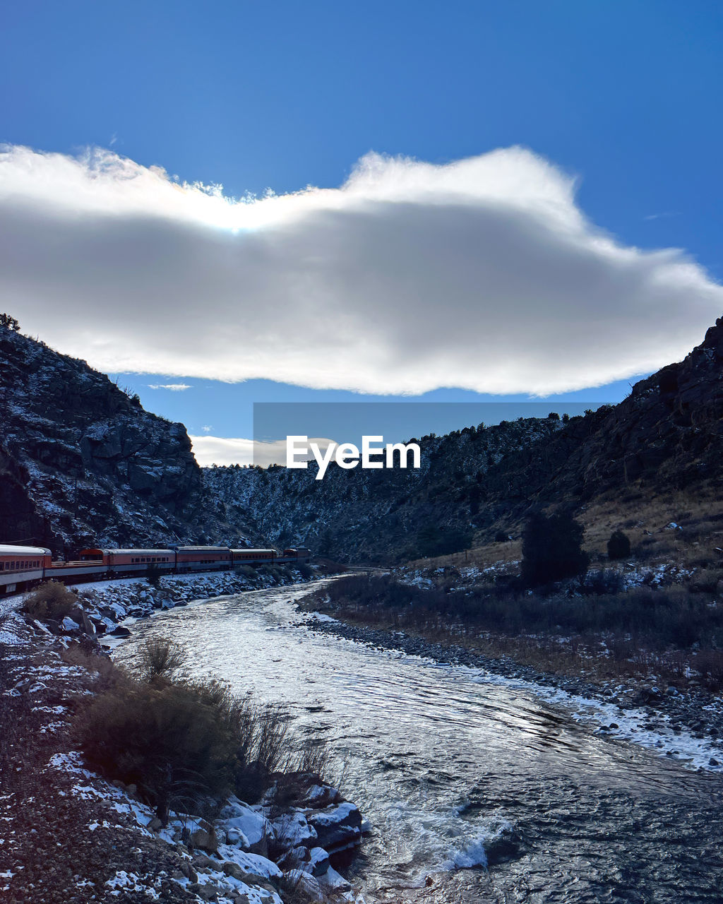 mountain, nature, sky, environment, snow, winter, scenics - nature, cloud, landscape, beauty in nature, mountain range, cold temperature, wilderness, water, reflection, no people, land, travel, travel destinations, blue, lake, tranquility, non-urban scene, outdoors, tranquil scene, tree, tourism, forest, day, plant, pinaceae, snowcapped mountain, ice, coniferous tree