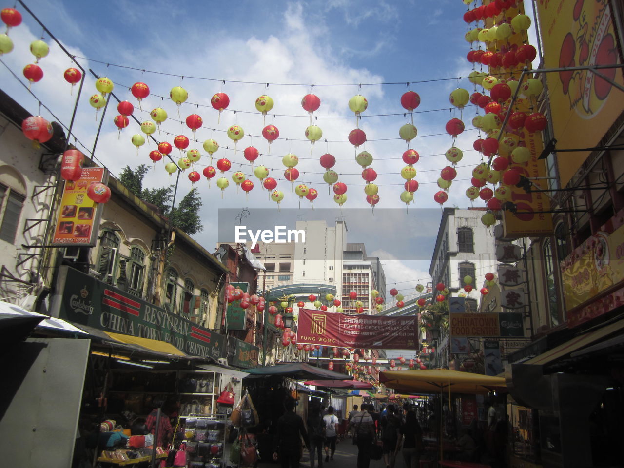 LOW ANGLE VIEW OF BALLOONS HANGING AGAINST SKY