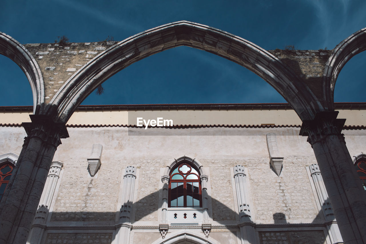 Low angle view of arch and building against sky