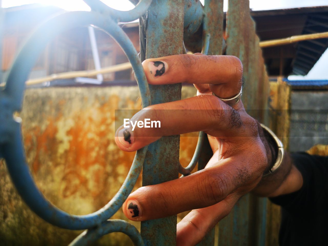Close-up of hand holding rusty metal