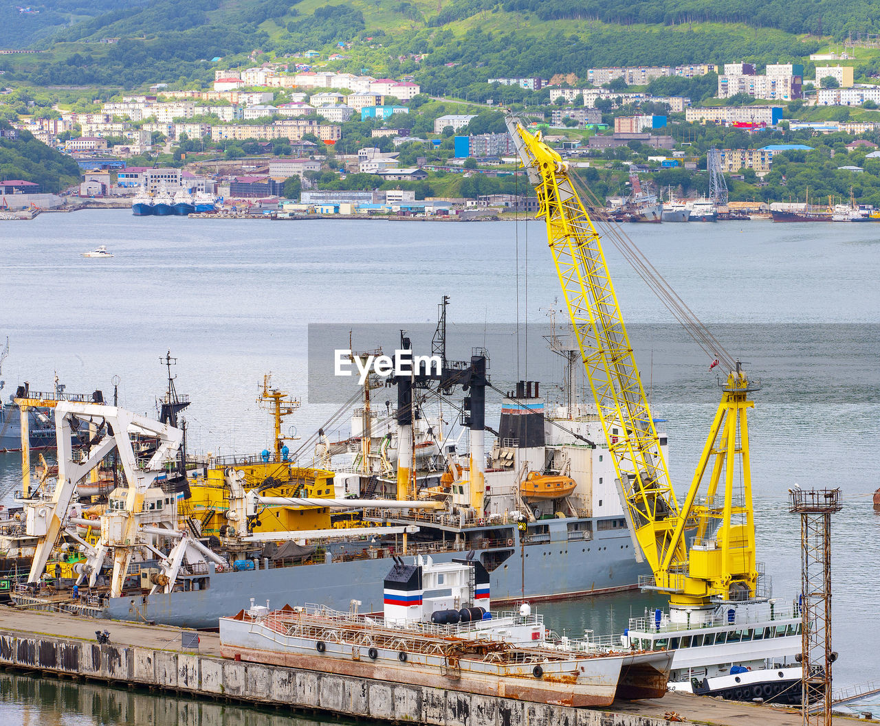 Ships at pier, port cranes on commercial seaport petropavlovsk-kamchatsky