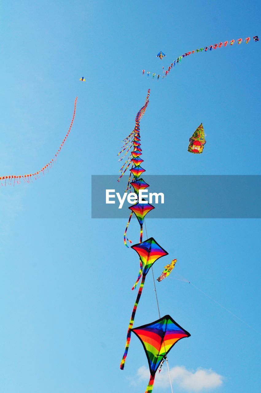 LOW ANGLE VIEW OF KITE FLYING HANGING AGAINST SKY