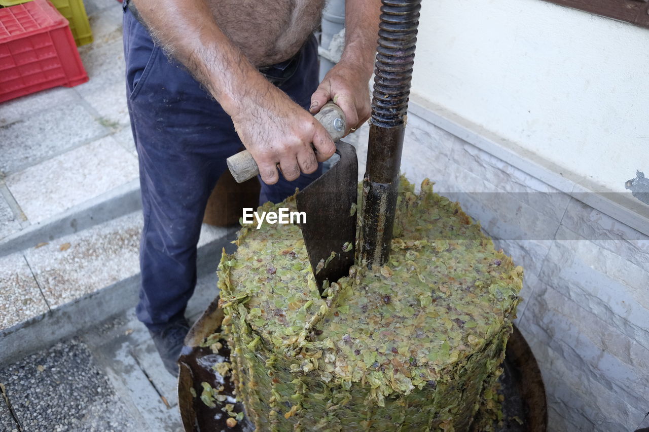 Low section of man working in winery