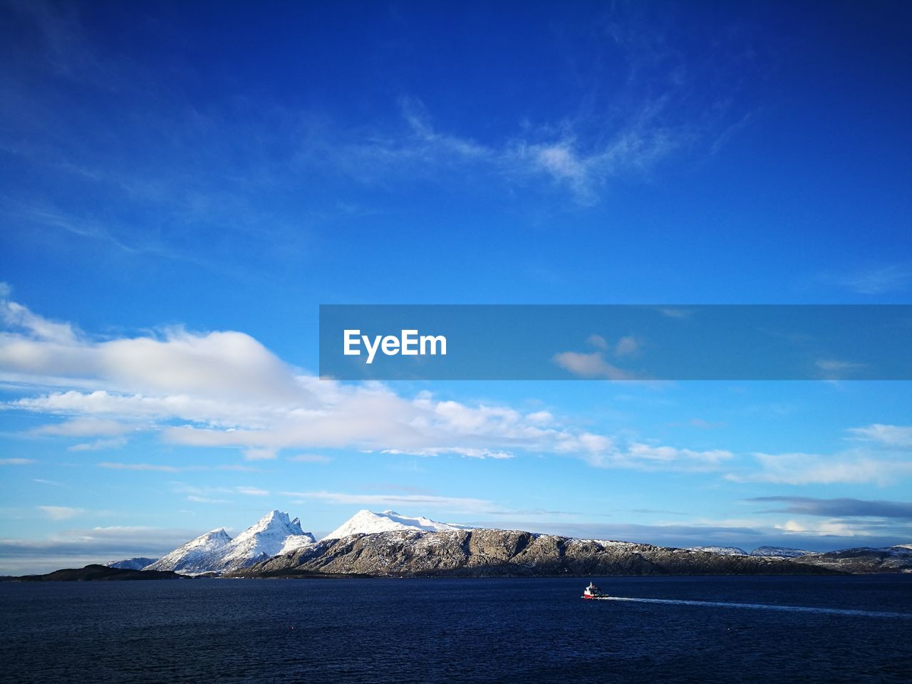 Scenic view of sea against blue sky