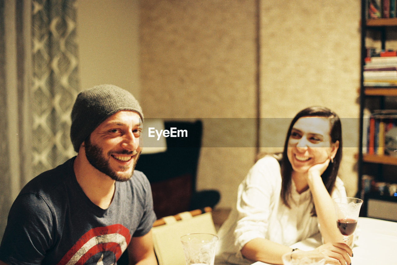 Portrait of smiling man with woman at restaurant