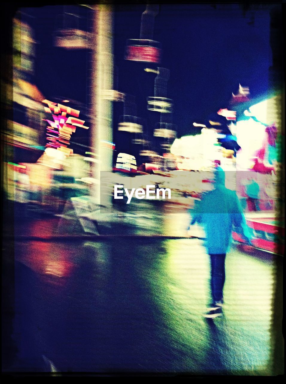 Defocused image of man walking on city street