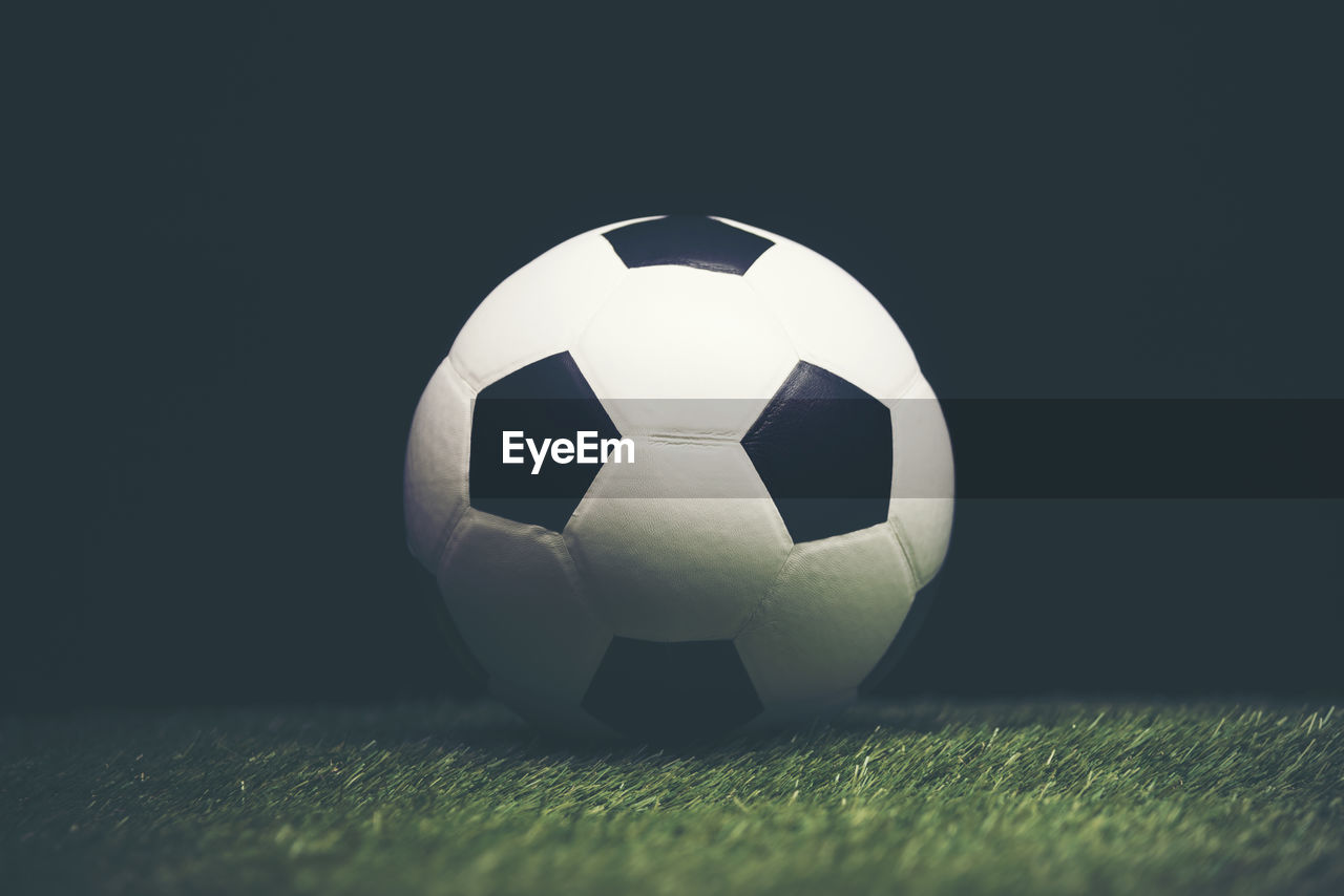 Close-up of soccer ball on playing field