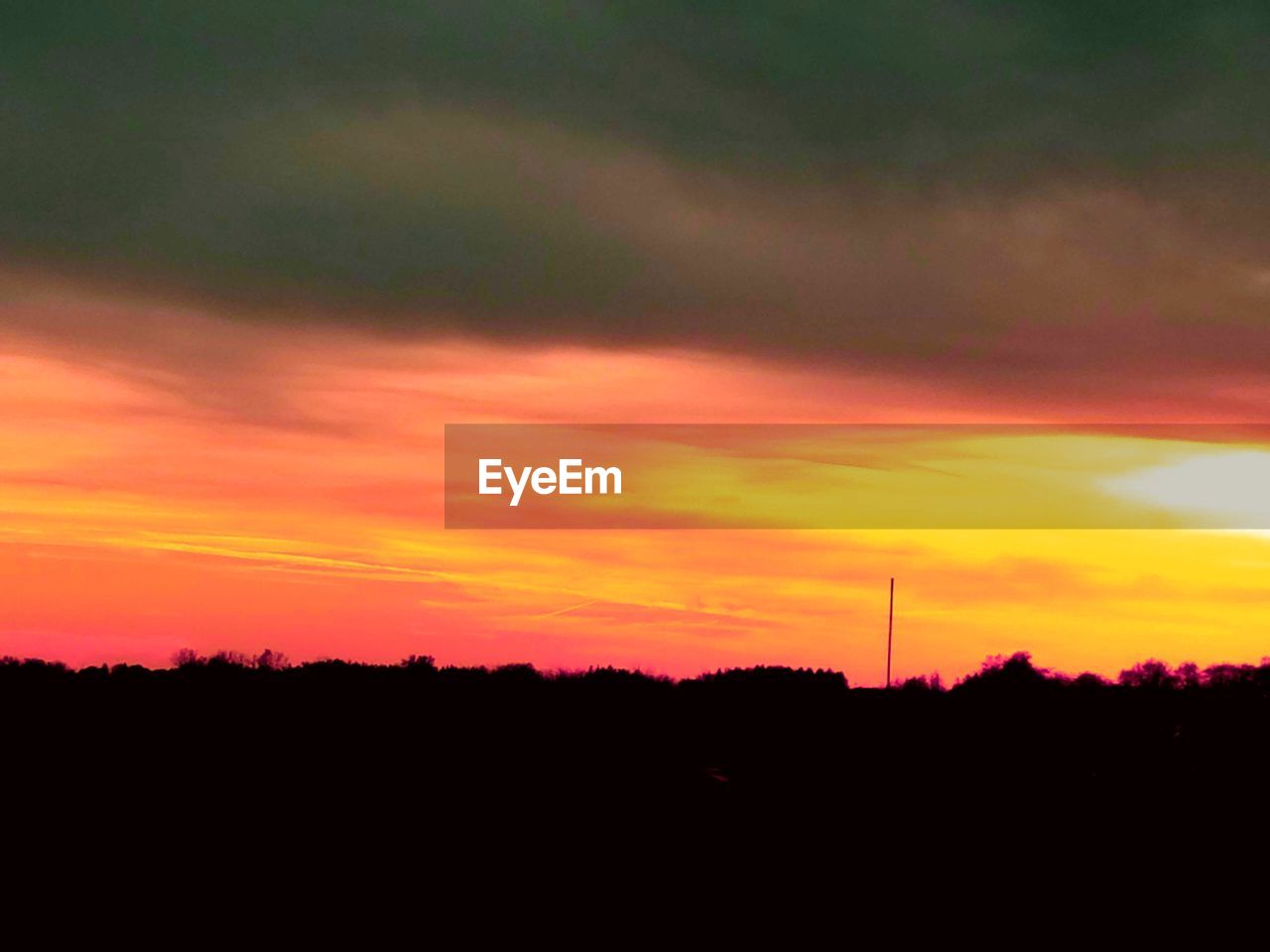 SILHOUETTE OF LANDSCAPE AGAINST SUNSET SKY