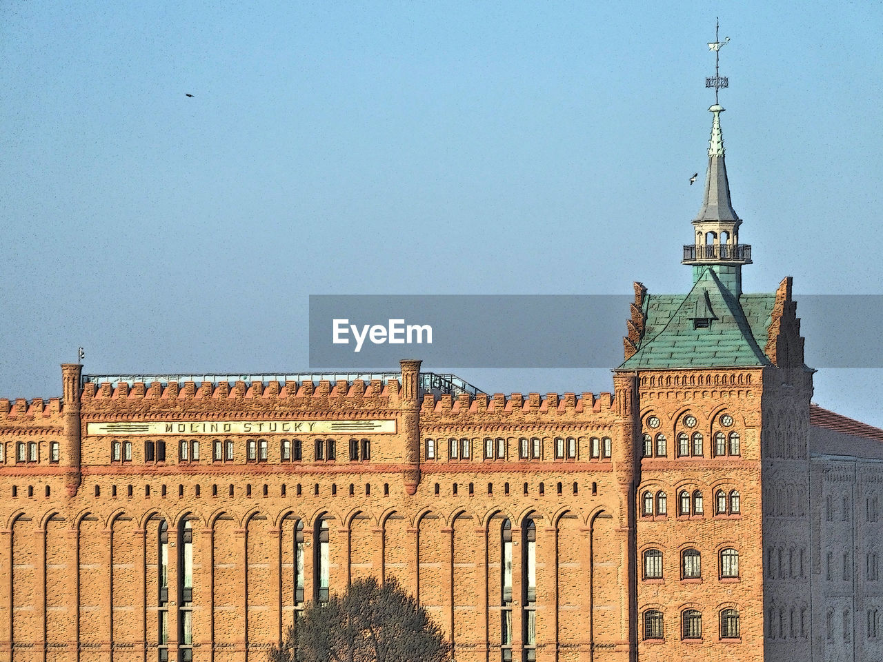 Low angle view of building against clear blue sky