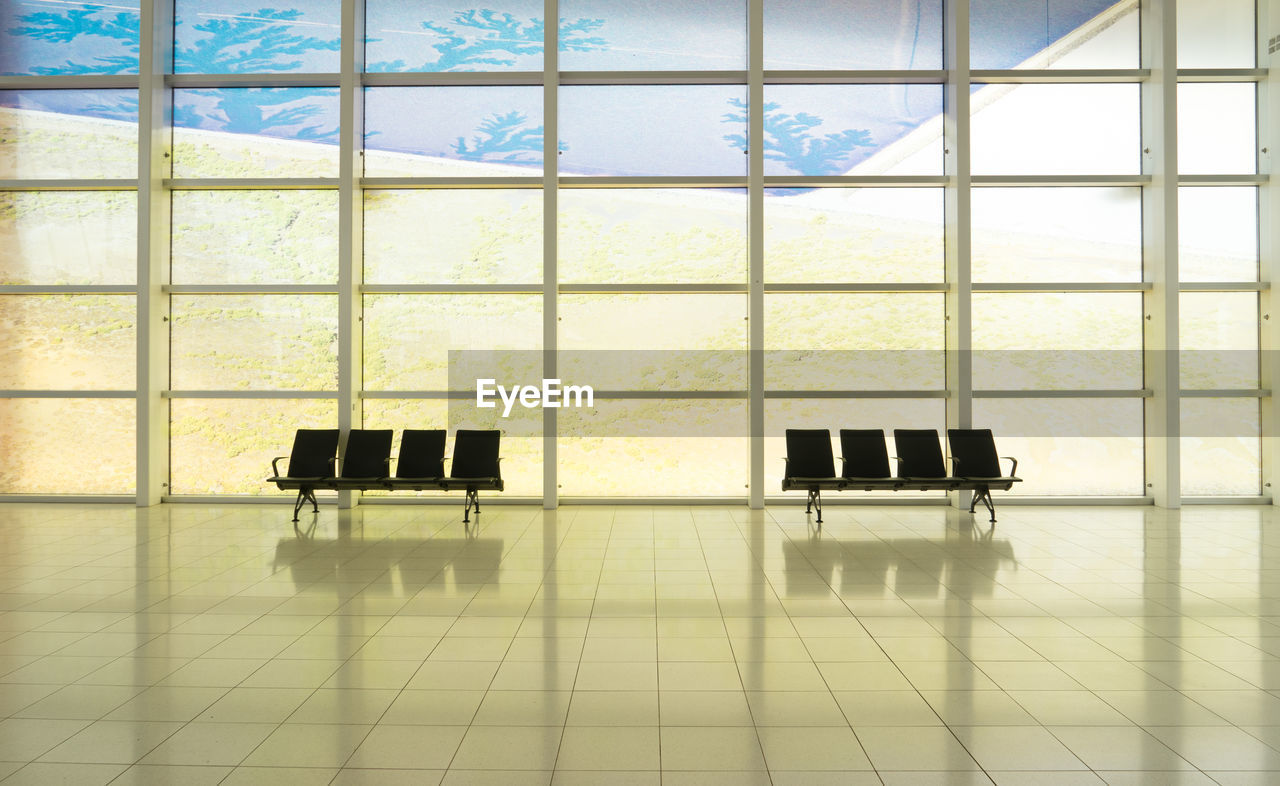 Digital composite image of empty chairs in building